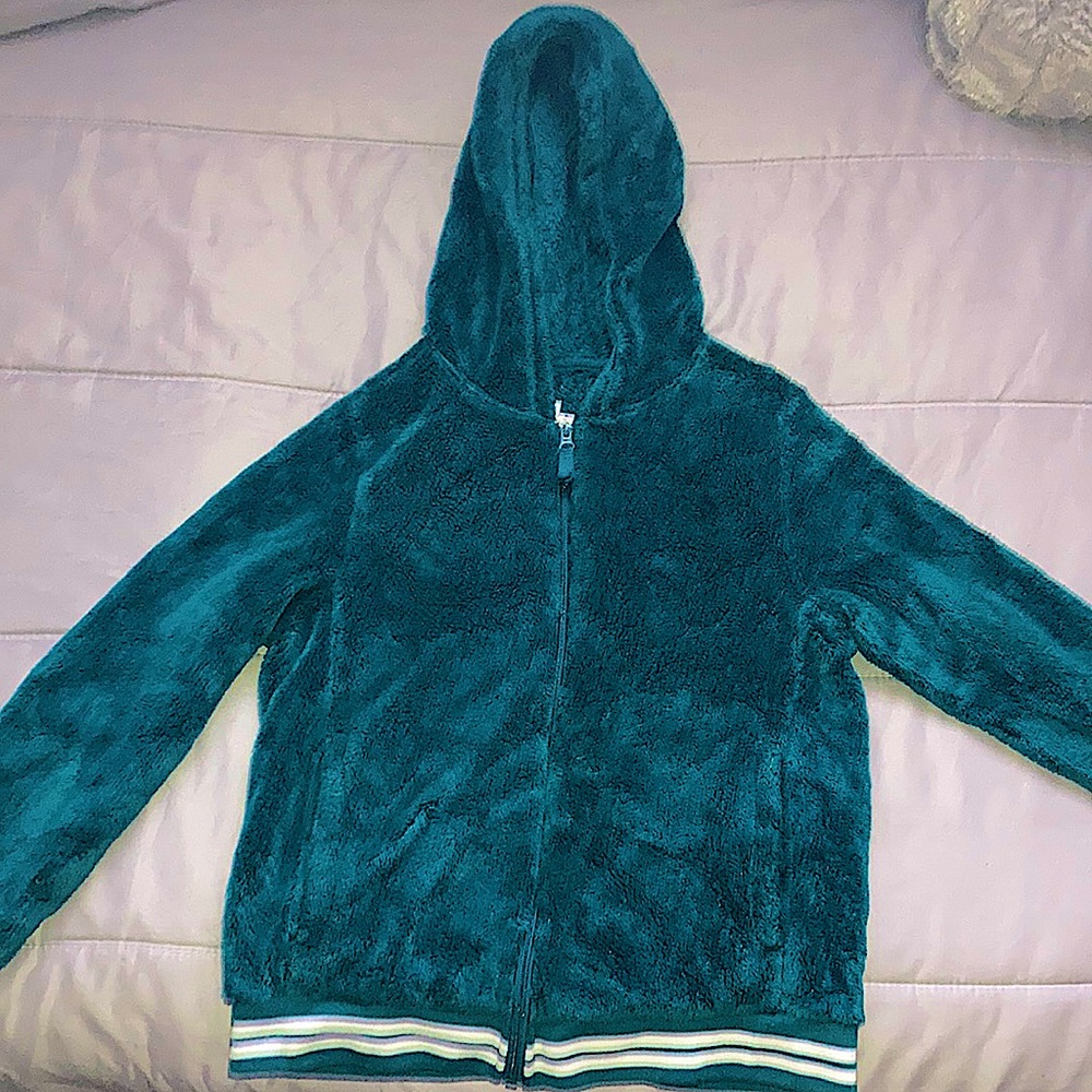 This is Sweatshirt it is warm from the inside and the outside it is a Teal blue.